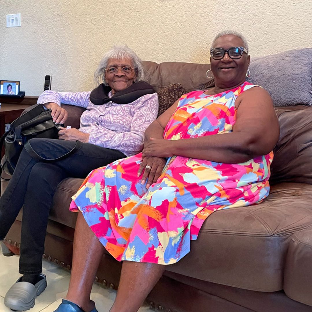 Senior Companion Program volunteer from Seniors in Service visiting with an older adult at home in Tampa Bay, sharing conversation and friendship.